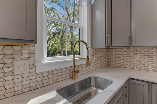11555 New Cut Rd, Campobello, SC 29322 - kitchen with gray cabinetry, backsplash, and light stone counters