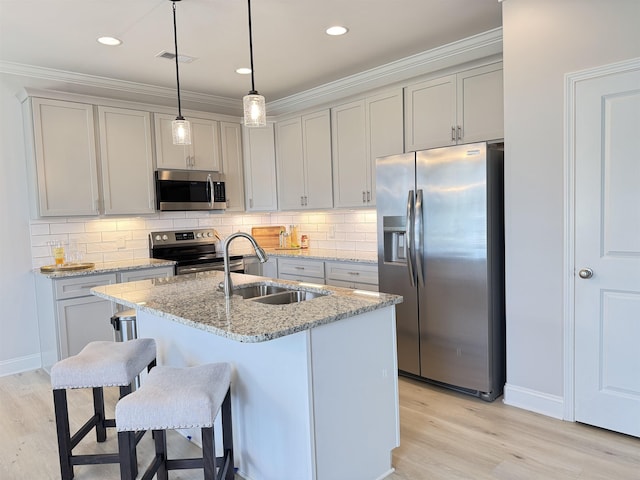 2601 Karkinnen Way, Moore, SC 29369 - kitchen featuring stainless steel appliances, light wood finished floors, backsplash, light stone countertops, and ornamental molding
