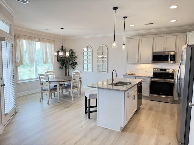 2601 Karkinnen Way, Moore, SC 29369 - kitchen with appliances with stainless steel finishes, crown molding, plenty of natural light, light wood-type flooring, and recessed lighting