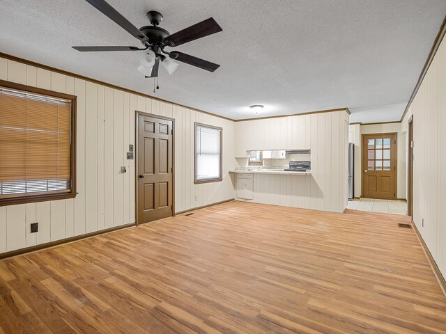308 Pine Lake Ct, Spartanburg, SC 29301 - unfurnished living room featuring light wood-style floors, ornamental molding, a textured ceiling, plenty of natural light, and a ceiling fan