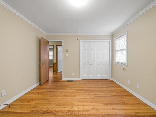 308 Pine Lake Ct, Spartanburg, SC 29301 - unfurnished bedroom with crown molding, light wood-style floors, and a closet