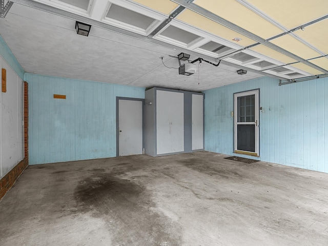 308 Pine Lake Ct, Spartanburg, SC 29301 - garage featuring a garage door opener and wood walls