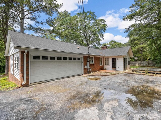 308 Pine Lake Ct, Spartanburg, SC 29301 - single story home featuring brick siding, asphalt driveway, a garage, and a chimney