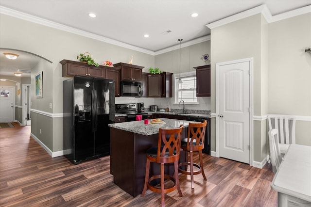 906 John Thomas Way, Greer, SC 29651 - kitchen with black appliances, a kitchen island, dark brown cabinets, dark wood-style floors, and arched walkways