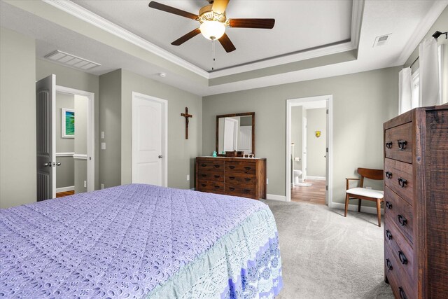 906 John Thomas Way, Greer, SC 29651 - carpeted bedroom featuring a tray ceiling, ceiling fan, crown molding, and ensuite bathroom