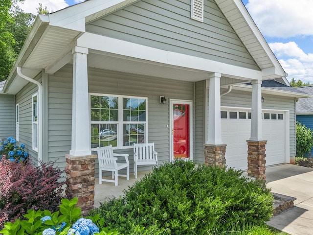 234 Page Creek Blvd, Landrum, SC 29356 - view of front of property featuring covered porch, driveway, an attached garage, and stone siding