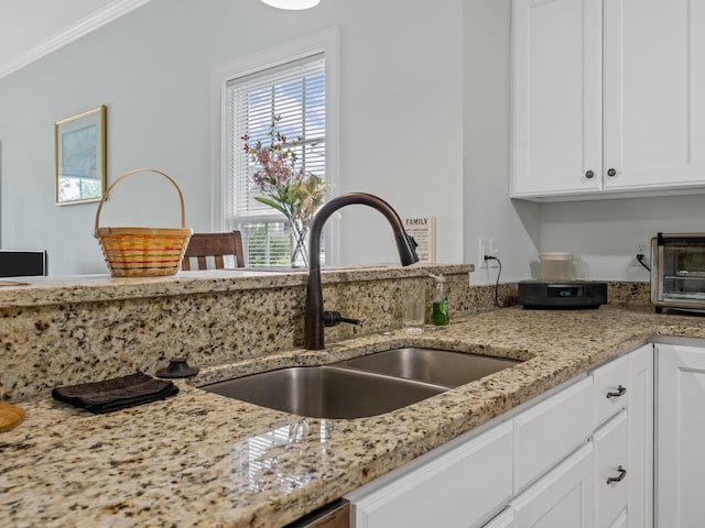 234 Page Creek Blvd, Landrum, SC 29356 - kitchen with white cabinetry, ornamental molding, and light stone countertops