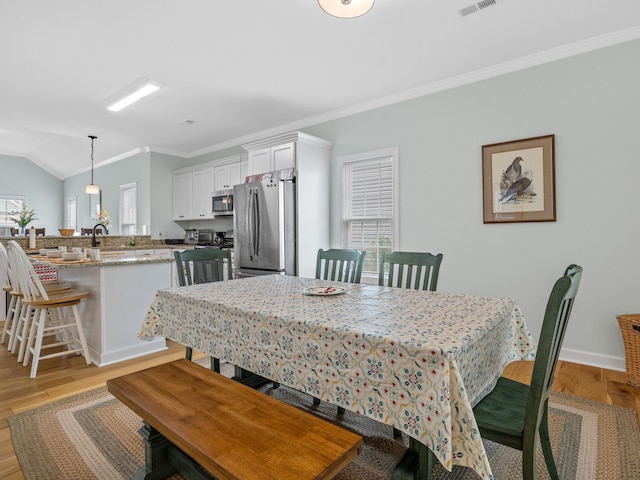 234 Page Creek Blvd, Landrum, SC 29356 - dining room with crown molding, healthy amount of natural light, light wood-style floors, and lofted ceiling