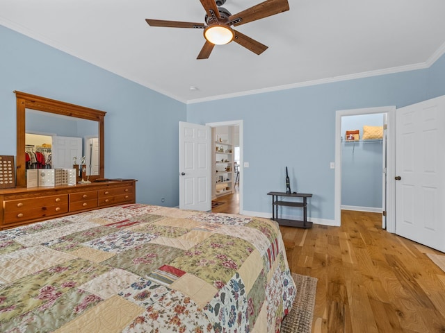234 Page Creek Blvd, Landrum, SC 29356 - bedroom with ornamental molding, wood finished floors, a spacious closet, a ceiling fan, and a closet