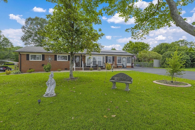 208 Kenneth Dr, Boiling Springs, SC 29316 - view of front of home featuring crawl space, roof mounted solar panels, a front lawn, brick siding, and asphalt driveway