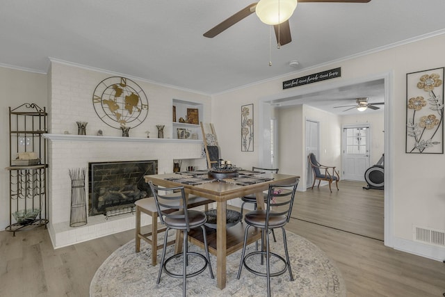 208 Kenneth Dr, Boiling Springs, SC 29316 - dining area with a ceiling fan, wood finished floors, crown molding, and a fireplace