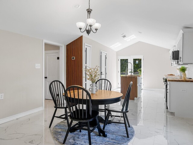 116 Dodd St, Wellford, SC 29385 - dining room with light marble finish flooring, a chandelier, and vaulted ceiling