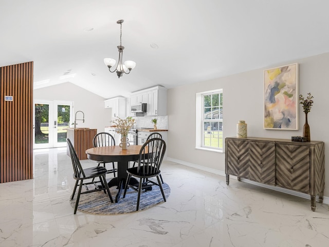 116 Dodd St, Wellford, SC 29385 - dining area with light marble finish flooring, a chandelier, vaulted ceiling, and french doors