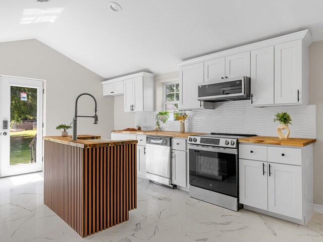 116 Dodd St, Wellford, SC 29385 - kitchen with appliances with stainless steel finishes, butcher block countertops, tasteful backsplash, light marble finish floors, and white cabinetry