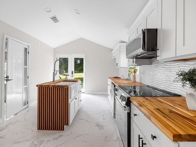 116 Dodd St, Wellford, SC 29385 - kitchen featuring butcher block counters, range with electric stovetop, stainless steel microwave, french doors, and lofted ceiling