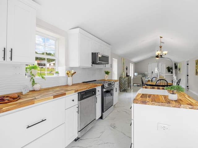 116 Dodd St, Wellford, SC 29385 - kitchen with appliances with stainless steel finishes, wood counters, light marble finish flooring, a chandelier, and vaulted ceiling