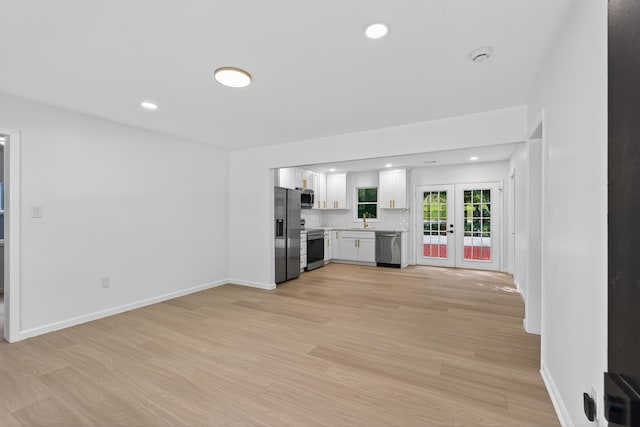 177 Lincoln Dr, Spartanburg, SC 29306 - kitchen with light countertops, stainless steel appliances, french doors, white cabinetry, and light wood-type flooring