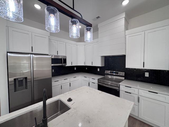451 Park St, Inman, SC 29349 - kitchen with appliances with stainless steel finishes, light stone countertops, white cabinets, tasteful backsplash, and recessed lighting