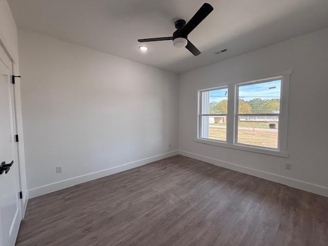 451 Park St, Inman, SC 29349 - unfurnished bedroom with wood finished floors and a ceiling fan