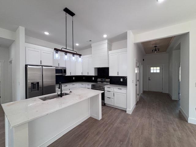 451 Park St, Inman, SC 29349 - kitchen with stainless steel appliances, dark wood-style floors, white cabinets, an island with sink, and pendant lighting