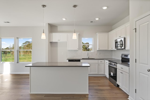 1465 Macedonia Rd, Gaffney, SC 29341 - kitchen with appliances with stainless steel finishes, dark countertops, backsplash, white cabinets, and dark wood-style floors