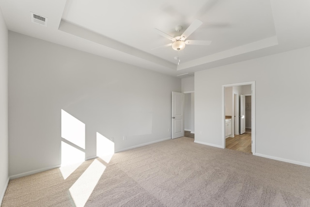 1465 Macedonia Rd, Gaffney, SC 29341 - unfurnished room with light carpet, a tray ceiling, and a ceiling fan