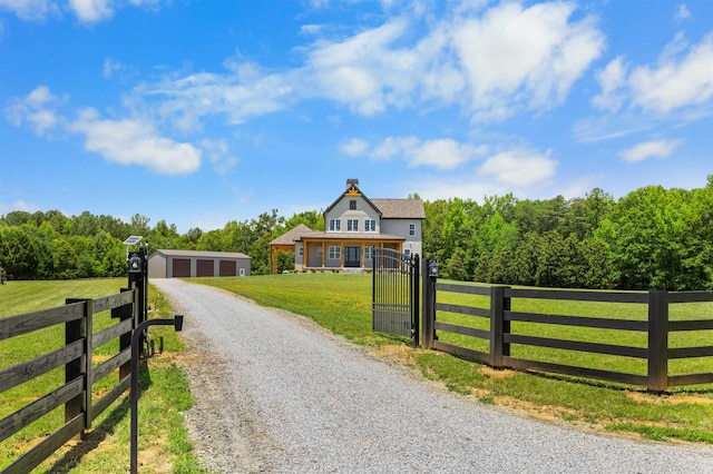 621 Bascule Ridge Ln, Campobello, SC 29322 - view of front of property featuring a fenced front yard, an outdoor structure, a detached garage, and a chimney