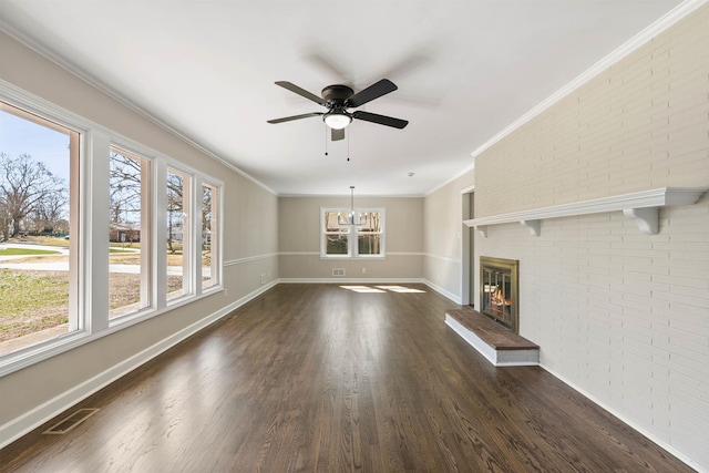 306 Fernwood Dr, Spartanburg, SC 29307 - unfurnished living room with brick wall, dark wood-type flooring, a ceiling fan, a fireplace, and crown molding