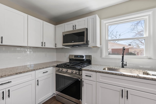 306 Fernwood Dr, Spartanburg, SC 29307 - kitchen featuring appliances with stainless steel finishes, white cabinets, and decorative backsplash