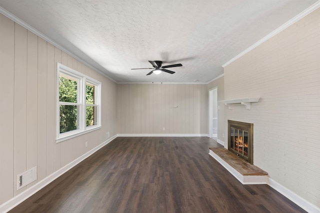306 Fernwood Dr, Spartanburg, SC 29307 - unfurnished living room with dark wood finished floors, a glass covered fireplace, a ceiling fan, crown molding, and a textured ceiling