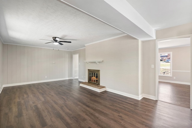 306 Fernwood Dr, Spartanburg, SC 29307 - unfurnished living room featuring a ceiling fan, a brick fireplace, dark wood finished floors, crown molding, and a textured ceiling