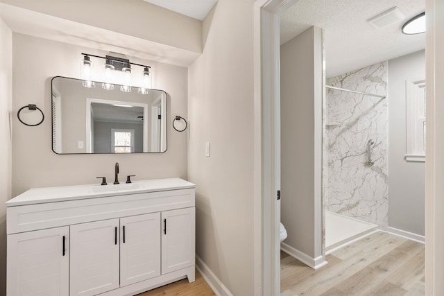 306 Fernwood Dr, Spartanburg, SC 29307 - bathroom with wood finished floors, a marble finish shower, and vanity