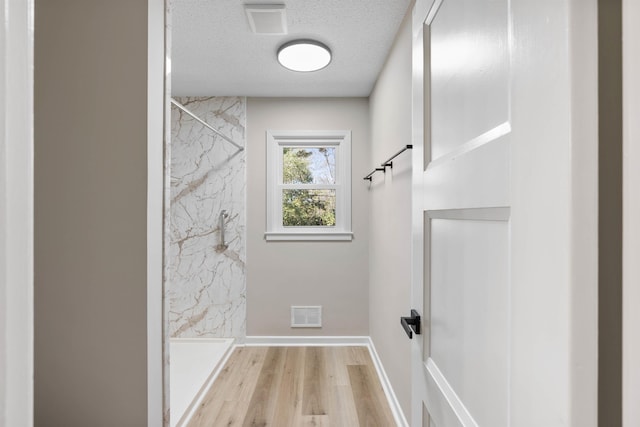 306 Fernwood Dr, Spartanburg, SC 29307 - full bathroom featuring a marble finish shower, wood finished floors, and a textured ceiling