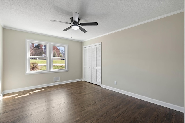 306 Fernwood Dr, Spartanburg, SC 29307 - unfurnished bedroom with a textured ceiling, dark wood finished floors, a closet, crown molding, and ceiling fan