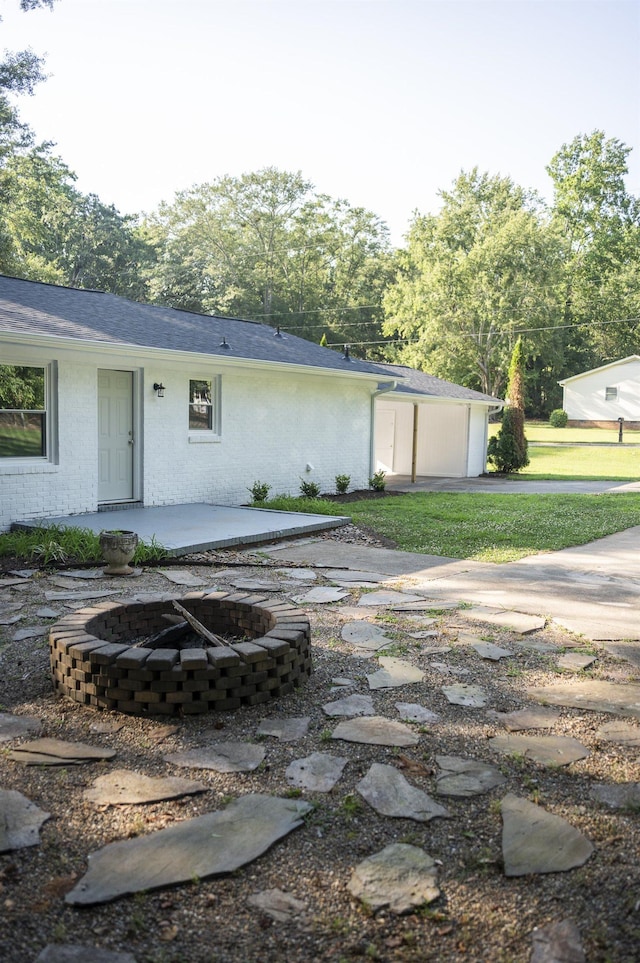 201 Bent Creek Dr, Greer, SC 29650 - rear view of property featuring a patio, an outdoor fire pit, brick siding, and a shingled roof