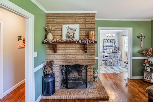 849 Harvey Rd, Greer, SC 29651 - living area featuring wood finished floors, a chandelier, ornamental molding, and a brick fireplace
