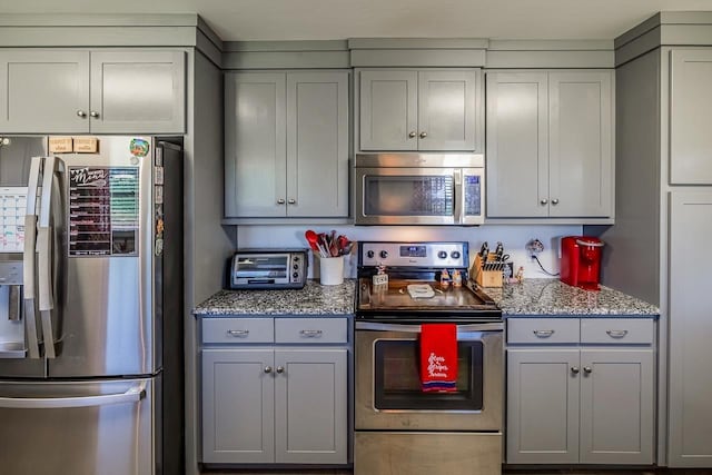849 Harvey Rd, Greer, SC 29651 - kitchen featuring appliances with stainless steel finishes, gray cabinetry, and light stone countertops