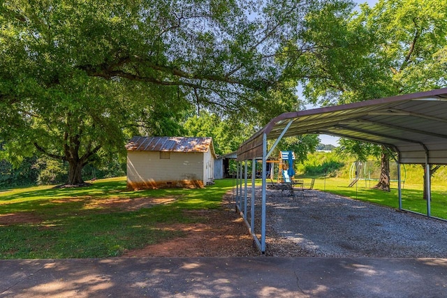 849 Harvey Rd, Greer, SC 29651 - view of grassy yard with a detached carport, driveway, an outdoor structure, and a playground