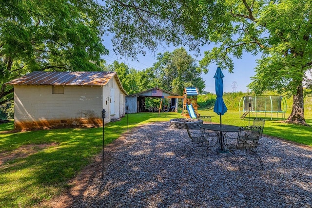 849 Harvey Rd, Greer, SC 29651 - view of green lawn featuring a trampoline, a playground, and a shed