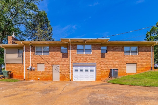 849 Harvey Rd, Greer, SC 29651 - rear view of property with a garage, concrete driveway, a chimney, and brick siding