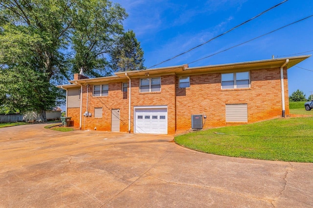 849 Harvey Rd, Greer, SC 29651 - back of property with driveway, an attached garage, a chimney, a yard, and brick siding
