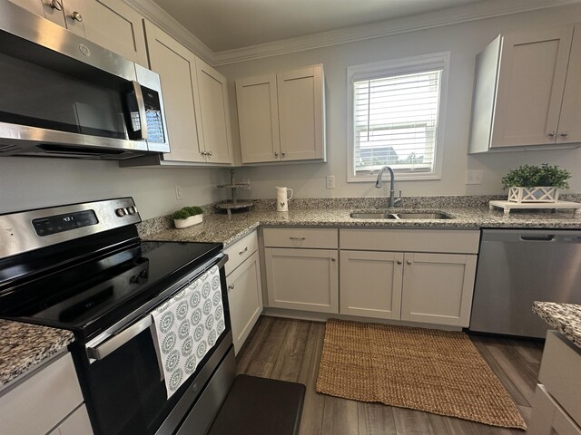 101 Deno Dr, Gaffney, SC 29341 - kitchen featuring appliances with stainless steel finishes, dark wood-type flooring, ornamental molding, and light stone countertops
