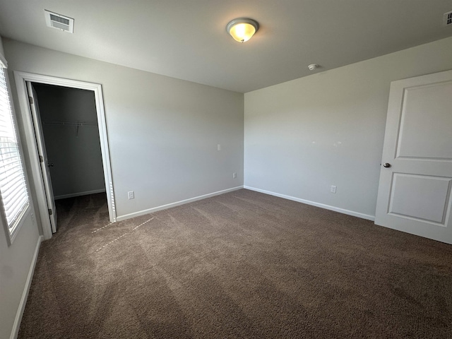 101 Deno Dr, Gaffney, SC 29341 - unfurnished bedroom with dark colored carpet, a walk in closet, and a closet