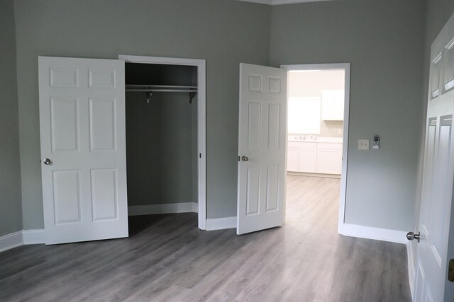 305 Spring St, Union, SC 29379 - unfurnished bedroom featuring wood finished floors, a closet, and a towering ceiling