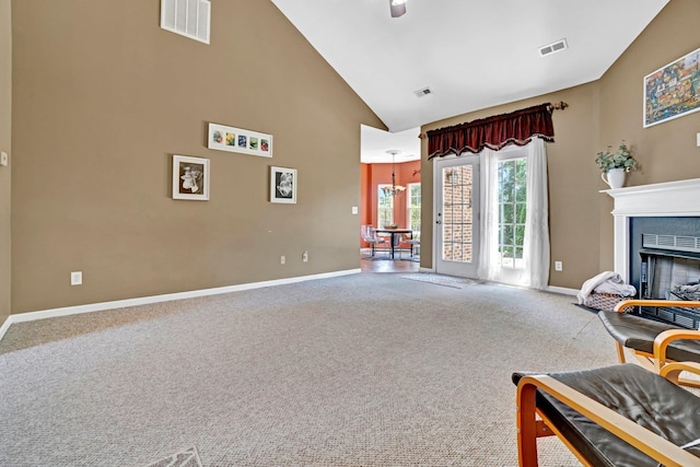 711 Waxwing Ct, Boiling Springs, SC 29316 - carpeted living room featuring high vaulted ceiling, a fireplace, and a chandelier