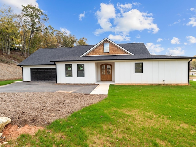 278 Forest Ave, Landrum, SC 29356 - view of front facade with board and batten siding, an attached garage, asphalt driveway, a front yard, and roof with shingles