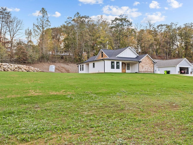 278 Forest Ave, Landrum, SC 29356 - view of front of property featuring board and batten siding, a front yard, a garage, and view of wooded area