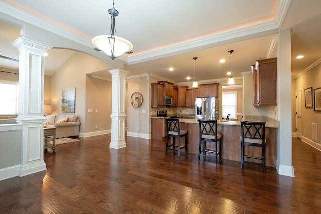 110 Coal Creek Dr, Boiling Springs, SC 29316 - kitchen with ornate columns, stainless steel appliances, a peninsula, open floor plan, and brown cabinetry