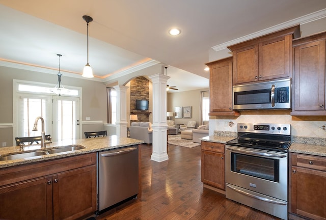 110 Coal Creek Dr, Boiling Springs, SC 29316 - kitchen featuring decorative columns, appliances with stainless steel finishes, crown molding, brown cabinetry, and dark wood finished floors