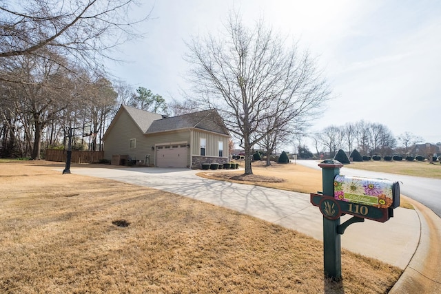 110 Coal Creek Dr, Boiling Springs, SC 29316 - view of side of home with a garage, concrete driveway, stone siding, and a lawn
